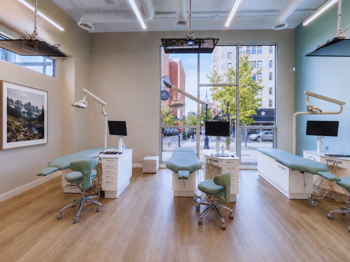 Finished startup orthodontic office treatment bay with dental chairs and a large street-facing window